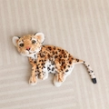 Close-up of soft snow leopard plush fabric with realistic spots and yellow eyes - 23CM / Squatting Leopard Shell