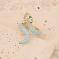 Macro detail of gold snake ring with light blue enamel and sparkling crystal head - Lake Blue