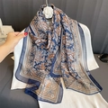 Long chiffon scarf with blue and brown paisley print layered on white knit sweater - Blue Brown Paisley