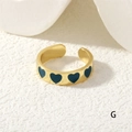 Detailed close-up of golden adjustable heart ring with blue enamel dripping oil craft - Deep Blue Hearts (RG0446-G)