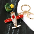 Golden airplane keychain with red enamel wings and sparkling rhinestones for handbags - Fighter Jet Red