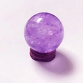 Natural purple amethyst crystal ball on a dark wooden base for home or office decor - Amethyst Ball