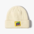 Winter knitted beanie in cream white with a bold yellow patch featuring 091 typography - Beige