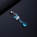 Macro shot of butterfly belly button ring with blue teardrop zircon and silver metal finish - Blue Butterfly Silver