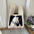 Knitted tote bag in off-white featuring a cute cartoon dog pattern with heart details - Cute Little Beige Puppy
