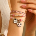 Bohemian friendship bracelet set with pink pig charm and Hi pendant on model wrist - Hi Piggy Style (WG-0459)