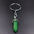 Detail shot of a green hexagonal crystal bullet pendant on a silver keychain ring - Green Aventurine
