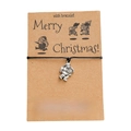 Detailed view of handmade woven Santa Claus charm bracelet on a Merry Christmas kraft card - Santa Claus