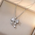 Silver bow necklace with pink zircon crystals on a warm gold jewelry box cover - Silver - White Zircon