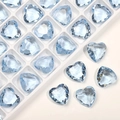 Macro shot of 12mm blue heart-shaped crystal rhinestones on a white grid and light surface - Light Blue Natural