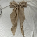 Elegant champagne satin bow hair clip with long ribbons and a silky shimmering finish - Khaki