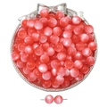 Detailed macro of pink cat eye glass beads for DIY jewelry making in a silver tray - 8mm / Hot Pink