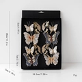 Set mit 10 bunten Stoffschmetterlings-Haarspangen in einer Premium-Geschenkbox - Schwarzgold
