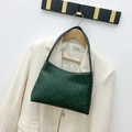 Dark green woven leather underarm bag featuring a minimalist semi-moon silhouette and texture - Green