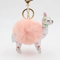 Detail of pink faux fur pompom and white leather alpaca pendant with golden keychain - Pink