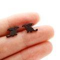 Macro shot of black stainless steel dragon earrings showing small size and detailed wings - Flying Dragon / Black