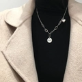 Detailed close-up of a silver-toned necklace featuring an engraved Smile tag and heart pendant - Round Tag Heart Necklace