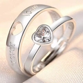 Macro shot of couple rings with heart-shaped zircon and Love Forever engraving - Love You Wholeheartedly