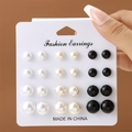 Detail of 12 pairs of pearl stud earrings set in white, beige, and black on a display card - 12 Pairs Set - Black White Beige Pearl Gradient