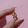 18K gold plated bow ring for women with minimalist aesthetic on a pink background - Gold Bowknot