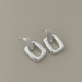 Close-up of minimalist geometric rectangular silver earrings with a polished finish - Silver