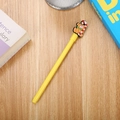 Cute yellow cartoon gel pen featuring a brown bear with a candy cane on a wooden desk - Little Bear Yellow