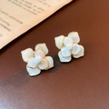 Vintage enamel floral stud earrings with white petals and gold trim on leather background - 925 Silver Pin Metal Edge Drip Oil Flower Style
