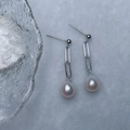 Elegant silver chain earrings featuring pink teardrop pearls and minimalist design - Silver