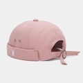 Detail of pink canvas docker hat showing white N embroidery and adjustable metal strap - Dusty Pink