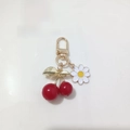 Golden cherry and white daisy pendant keychain with leaf details on white plate - Red Cherry with Yellow Core Daisy (Cherry J)