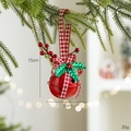 Red Christmas bell ornament with houndstooth bow and holly berries on a tree branch - Round with Bells / Red