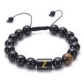 Macro detail of adjustable obsidian bead bracelet featuring a gold letter Z on tiger eye stone - Letter Z