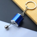 Detail of blue manual gear stick keychain with engraved shifting pattern on metallic base - Gear Shift Knob / Blue