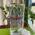 Macro detail of gradient cicada wing earrings with rhinestones on a glass rim - Green Pink Rhinestone