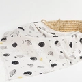 Bamboo cotton muslin baby swaddle blanket with universe planet pattern on a basket - Planet