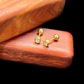 Close-up of gold screw-back cartilage earrings with sparkling round cubic zirconia stones - 4mm Barbell Style (Single) / Gold