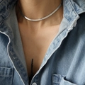 Close-up of a layered silver snake bone chain necklace worn with a denim shirt - Silver 4mm Width 36+8cm