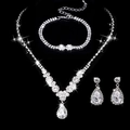Macro shot of silver bridal jewelry set with water-drop crystals on black background - 501+838 Necklace Stud Earrings Bracelet / Silver