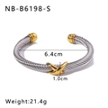 Detail view of a 6.4cm diameter two-tone cable cuff with golden X and sphere accents - Inter-Gold Spiral Style (NB-B6198-S) / 18K Gold