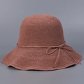 Macro detail of hand-crocheted caramel straw hat texture with fine bow decoration - Dusky Pink