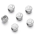 Macro detail of silver CCB plastic cylindrical spacer beads with clover engraved patterns - Silver Style 15 (Symbol Bead)