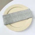 Grey ribbed knit sports headband for yoga placed on a cream ceramic plate - Gray