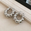 Macro shot of polished silver bubble hoop earrings with mirror finish on beige velvet tray - Silver Bubble Texture (HE29191)