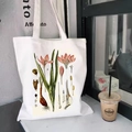 White canvas tote bag featuring vintage botanical floral prints and science illustrations - Botanical Science Illustration (STD344-H)