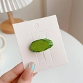Funny cucumber slice hair clip made of resin on a white display card by UYU - Cucumber Slice