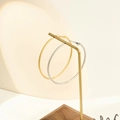 Textured gold and silver hoop earrings with intricate diagonal faceted carving on display - 50mm / Gold