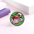 Macro shot of horror movie enamel pin featuring VHS tapes and a bloody slasher knife - VHS Tape Stack Horror Elements (XZ8908)