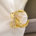 Adjustable gold geometric knot ring with sparkling zircon stones on white silk background - 14107 Bamboo Knot