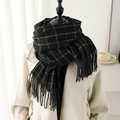 Detail shot of black and white plaid scarf with fringe tassels on a mannequin - 200x65cm / Black