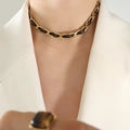 Elegantes Halsband aus schwarzem Leder und goldener Kette in geflochtenem Design - Halskette / 34+5cm / Gold